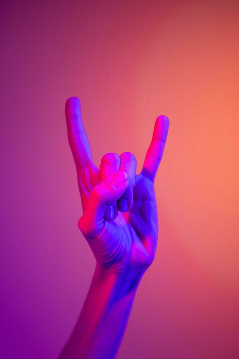 Handgebaar tegen oranje roze achtergrond